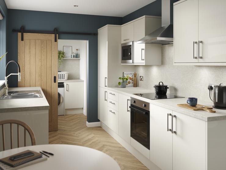 A porcelain, slab kitchen with a gloss finish in a galley layout. It has oak-effect flooring, integrated appliances and hob.