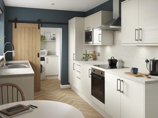 A porcelain, slab kitchen with a gloss finish in a galley layout. It has oak-effect flooring, integrated appliances and hob.