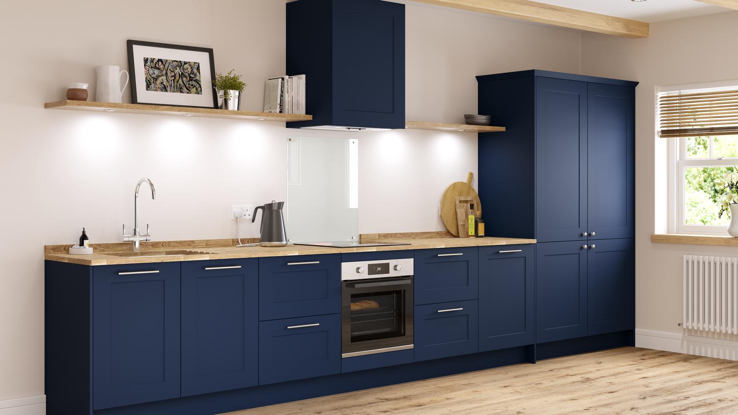 Navy blue shaker kitchen in galley layout with larder units, wooden worktop and undermount ceramic belfast sink