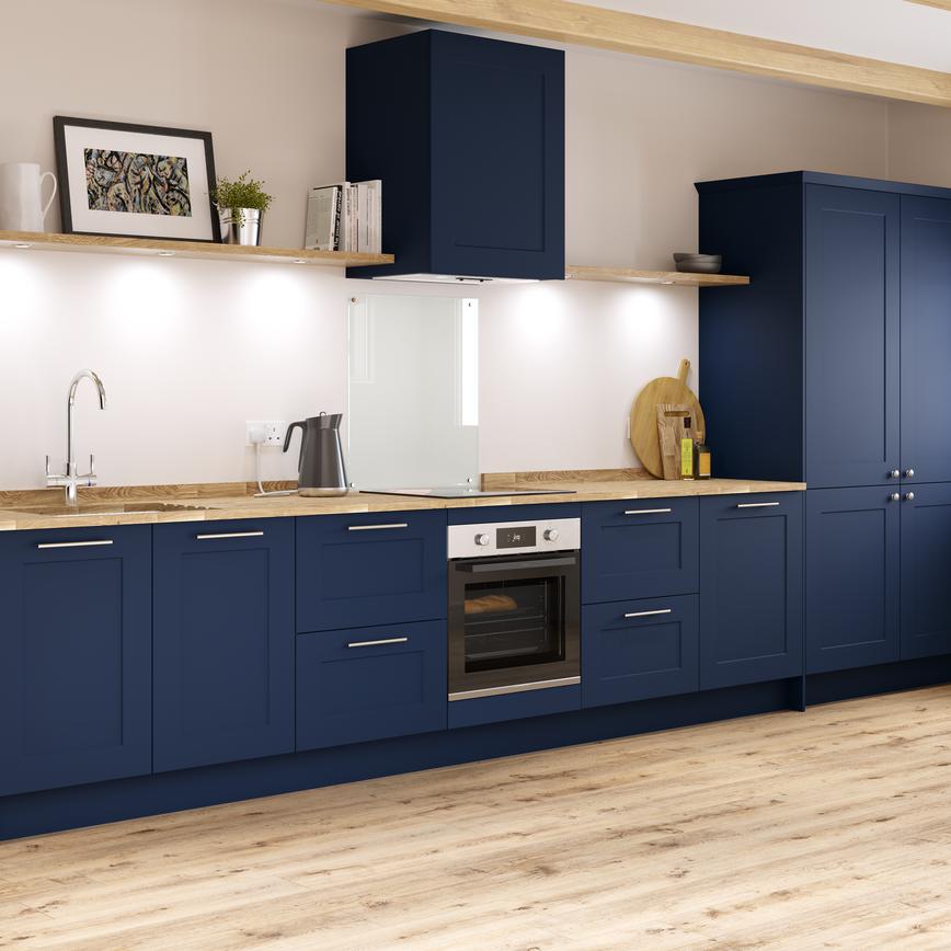 Navy blue shaker kitchen in galley layout with larder units, wooden worktop and undermount ceramic belfast sink