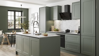 A green kitchen with handleless cabinets and a kitchen island. Features a white worktop and matching backboard.