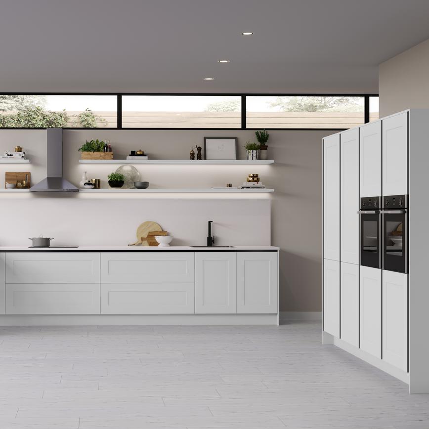 Modern white handleless shaker kitchen with full height tower units and side by side electric ovens