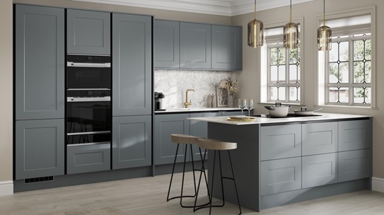 Handleless blue shaker kitchen with black trims in a peninsula layout. Contains a white breakfast bar and black double oven