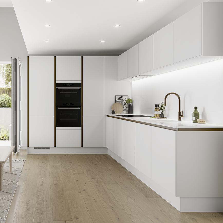 Contemporary L-shaped white kitchen idea with matt slab cupboard doors and a handleless design. Has white trims and worktops.