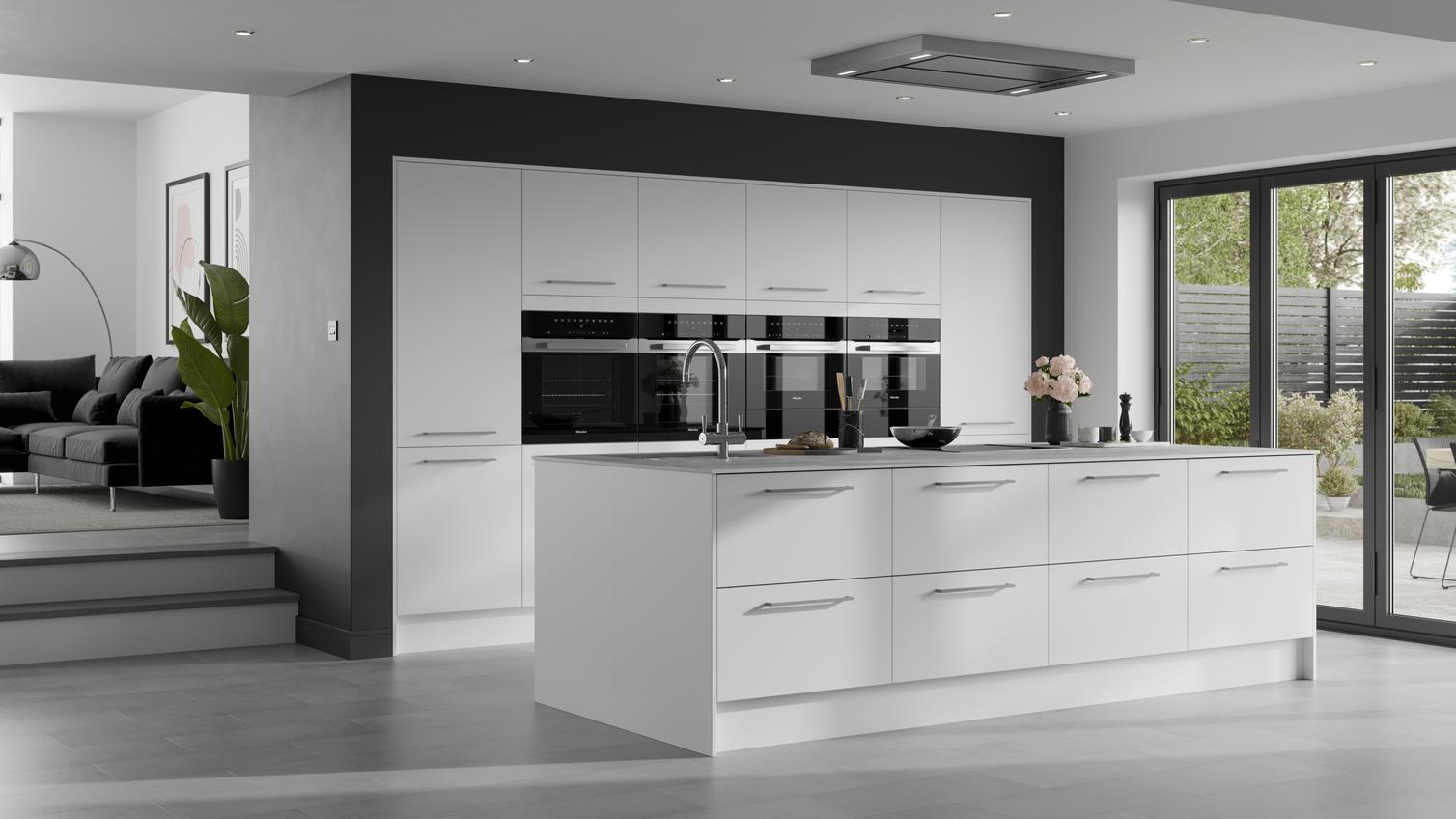 A white slab kitchen with matt finish and island layout. A monochrome design using black worktops, floors, and appliances.