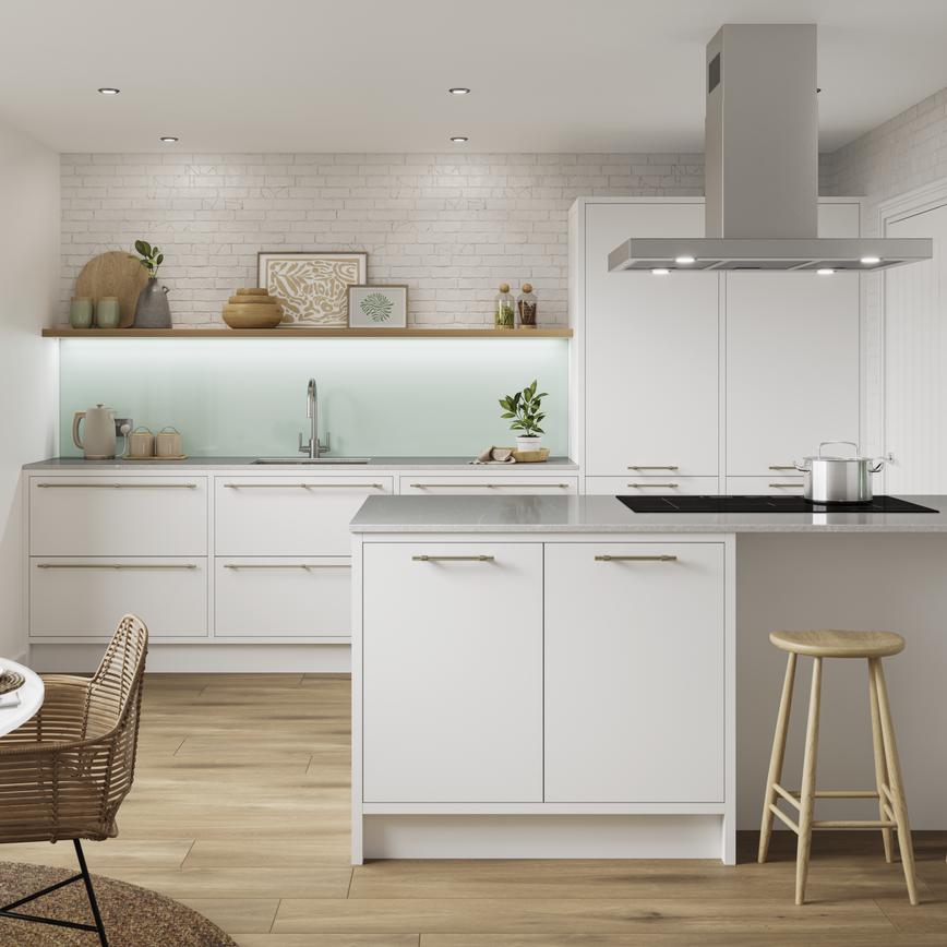 A white slab kitchen with in-frame cupboards in an island layout. Includes black worktops and handles for a monochrome look.