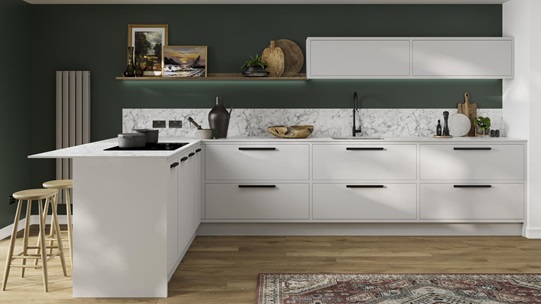 A dove-grey kitchen design with in-frame slab doors featuring black handles and a marble-effect surface and backboard