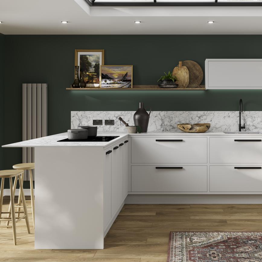 A dove-grey kitchen design with in-frame slab doors featuring black handles and a marble-effect surface and backboard