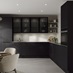L-shape black kitchen idea with super-matt slab doors, glass wall cabinets above a white worktop, and a chrome kitchen tap.