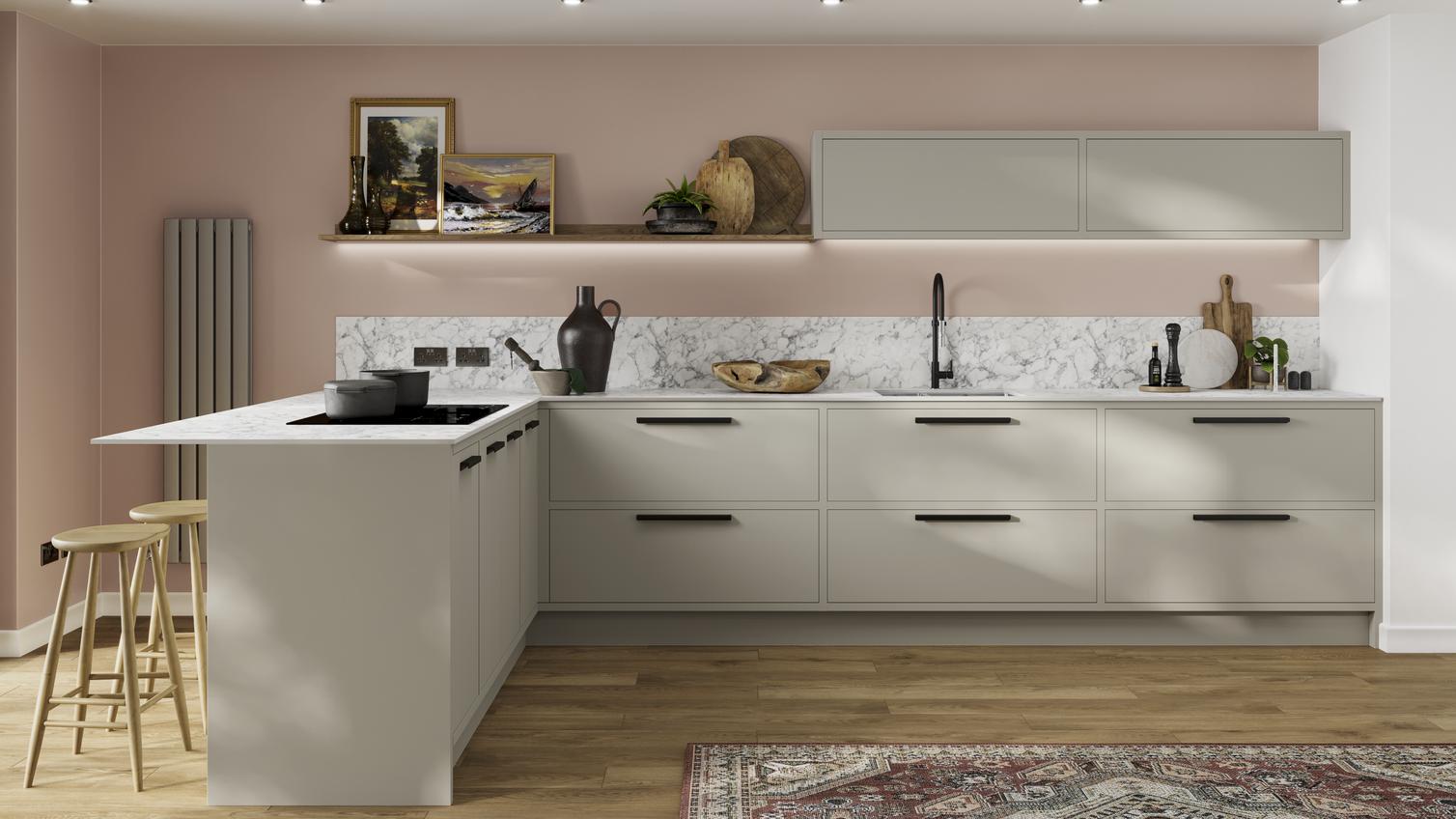Scandi-style cream L-shaped kitchen with in-frame slab doors. Has white marble worktops, a black tap, and an undermount sink.