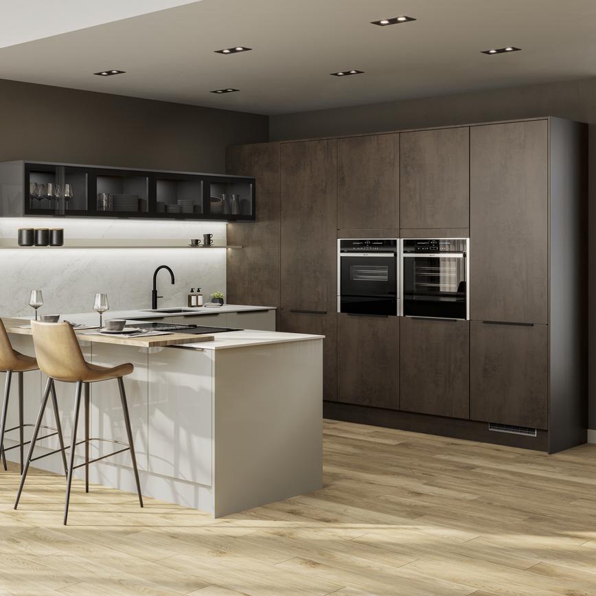 A contemporary two-tone kitchen with dark stone, cream slab doors, black handles, glazed wall units, and timber floors