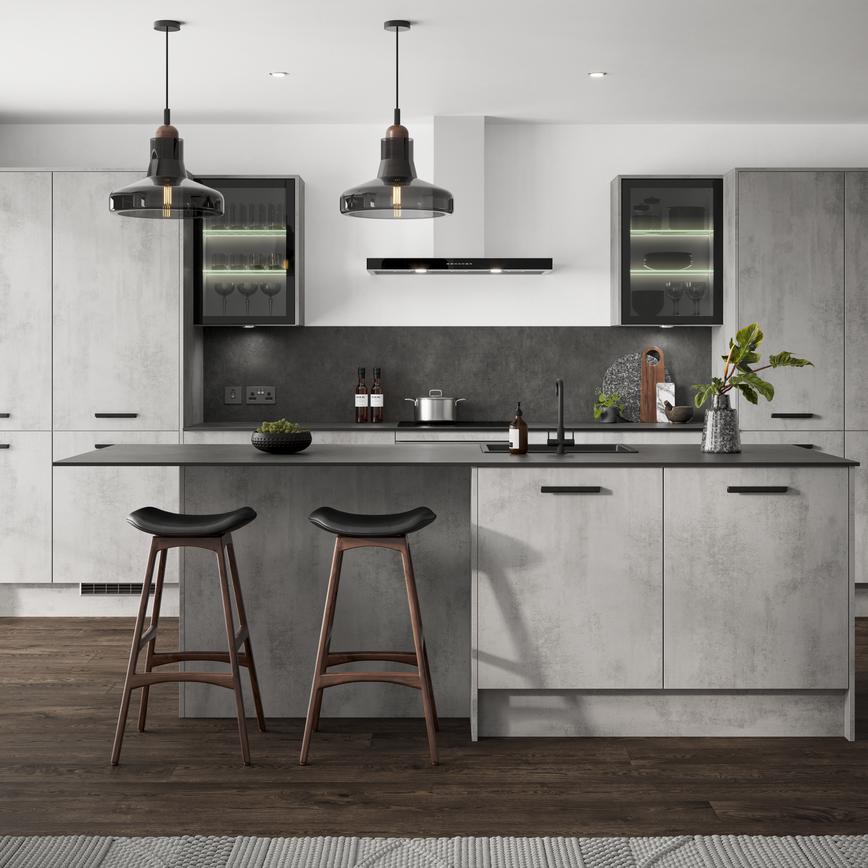 Grey kitchen in an island layout with concrete cupboard doors in a slab design. Includes black bar handles and glazed units.