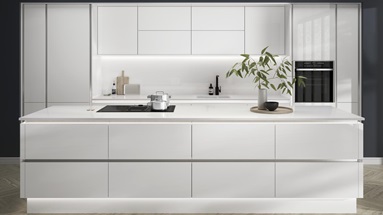 Open-plan white gloss kitchen idea with a linear design. Has white worktops and silver decorative trims for a modern feel.