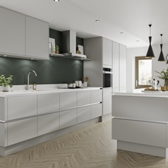Modern kitchen in dove grey with handleless kitchen doors and cabinet lighting. Breakfast bar with black pendant lights over.