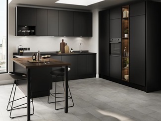 A kitchen with black cabinets and matching counter tops, including a dark wood-effect breakfast bar.