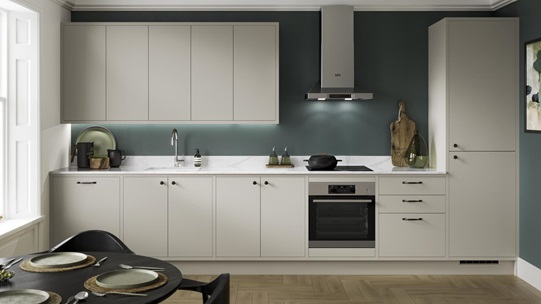 Scandi-style cream L-shaped kitchen with in-frame slab doors. Has white marble worktops, a black tap, and an undermount sink