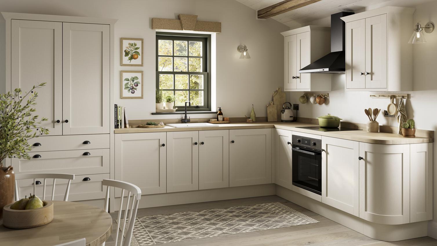 A white, shaker kitchen from the Halesworth porcelain range. It is in an l-shaped layout and features curved cabinet doors