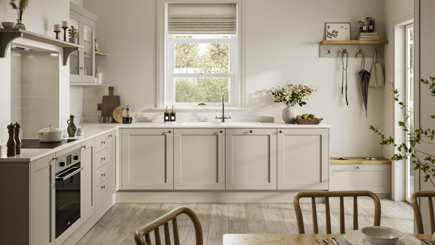 L-shaped, shaker kitchen in a cream, pebble colour. From the Halesworth range. Features white worktops and oak flooring
