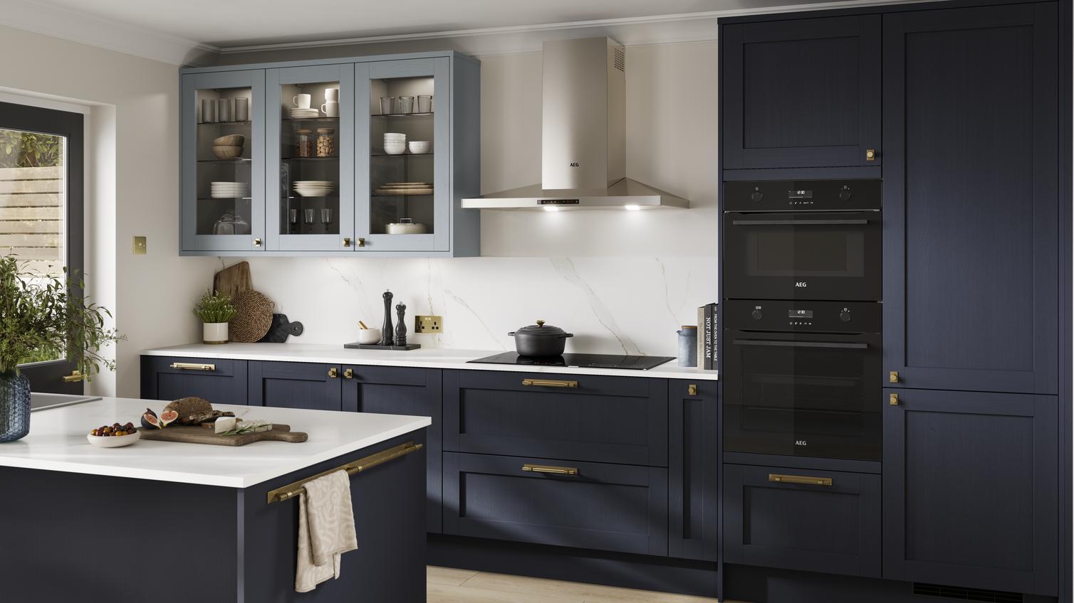 A dark, shaker-style Navy kitchen from the Halesworth range. Features integrated oven and hob, and a matching kitchen island
