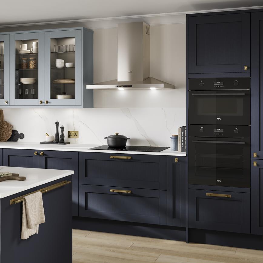 A dark, shaker-style Navy kitchen from the Halesworth range. Features integrated oven and hob, and a matching kitchen island