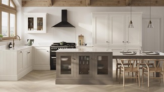 A porcelain shaker kitchen from Ilfracombe, in an l-shaped layout. It has a mushroom-toned island with glass base cabinets.