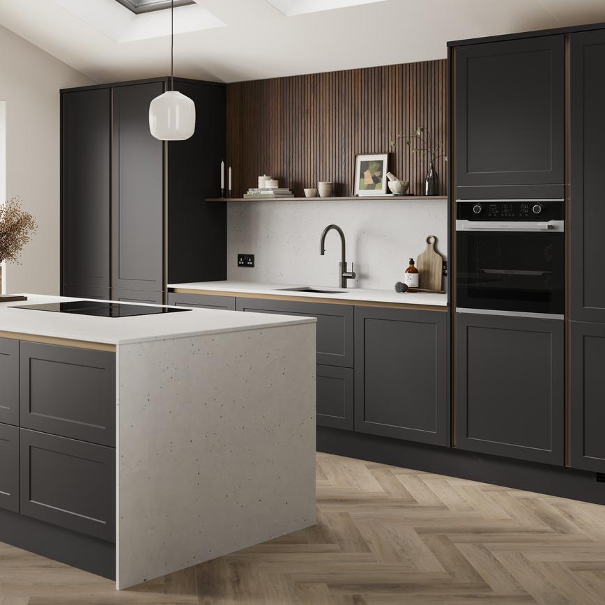 A charcoal black, shaker kitchen island in a handleless style & matt finish. It has quartz worktops with matching panels. 
