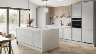 A dove grey, shaker kitchen island in a matt finish & handleless style. It has quartz worktops with side panels & backboard.