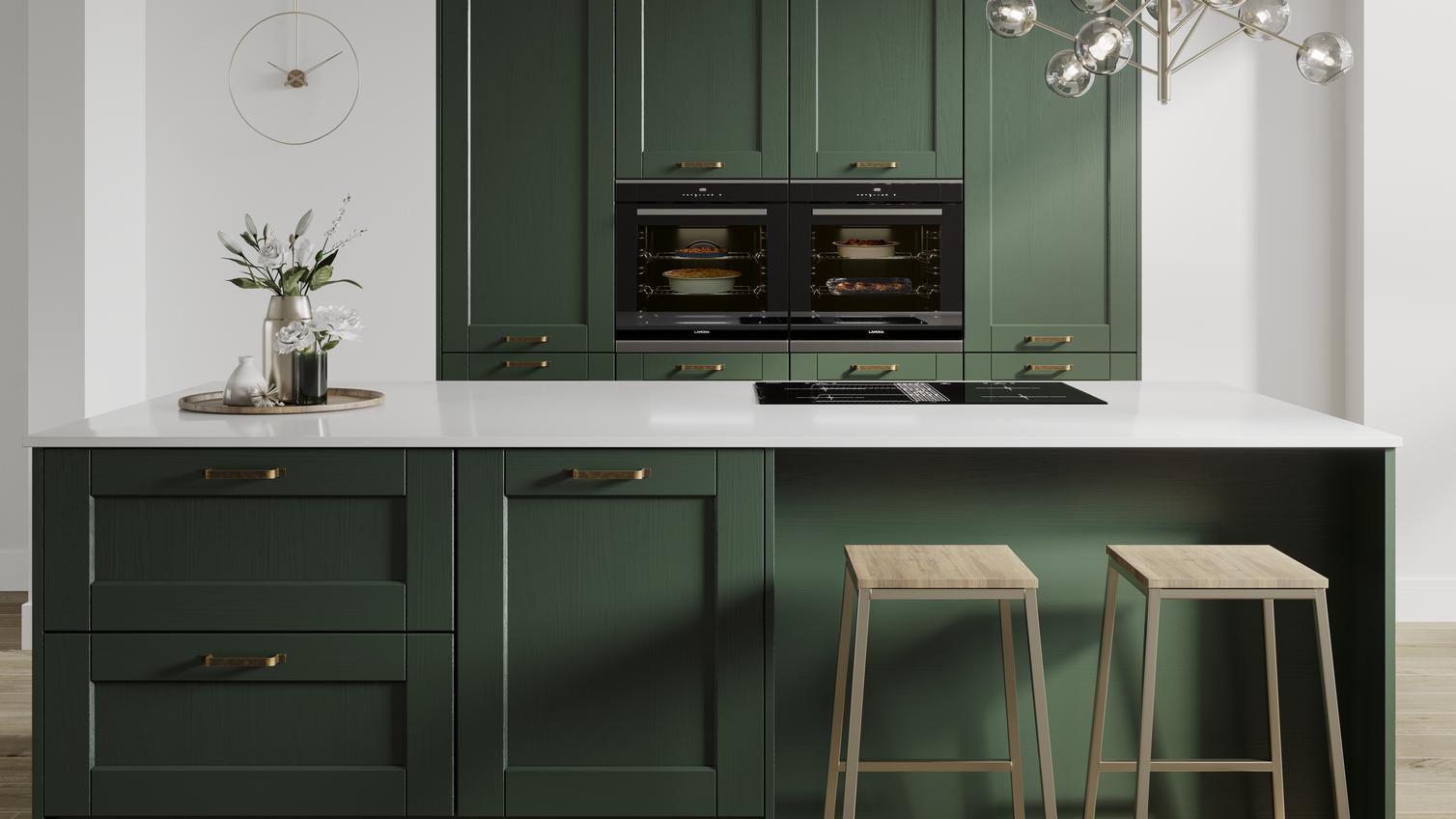 Designer green shaker kitchen with wood grain effect finish an island layout. Double larder units and two built in ovens.