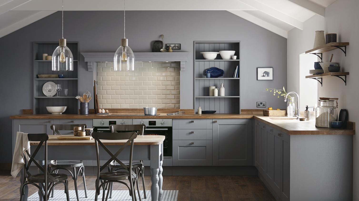 Farmhouse style shaker kitchen in slate grey with square edge wood worktop and classic wooden top dining table.