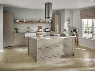 Cottage-style green shaker kitchen idea with island unit. Double bowl white ceramic sink with a single open shelf above.