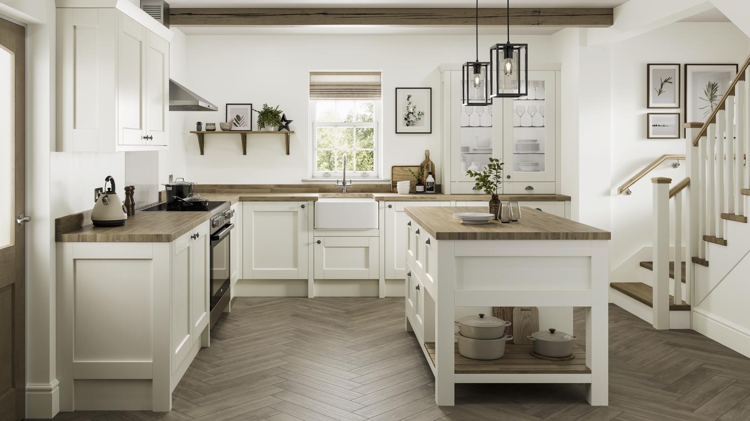 A large farmhouse kitchen in an island layout. Includes white shaker doors, solid oak worktops, and a white ceramic sink