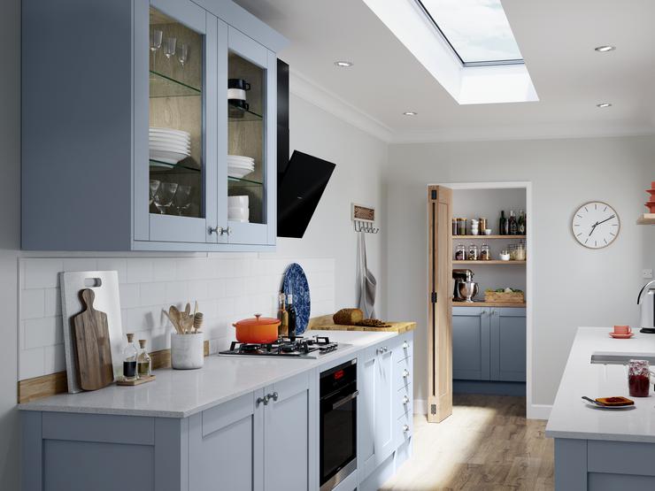 Scandinavian blue kitchen idea in galley layout with shaker cupboard doors, white worktops, open shelving and wood flooring.
