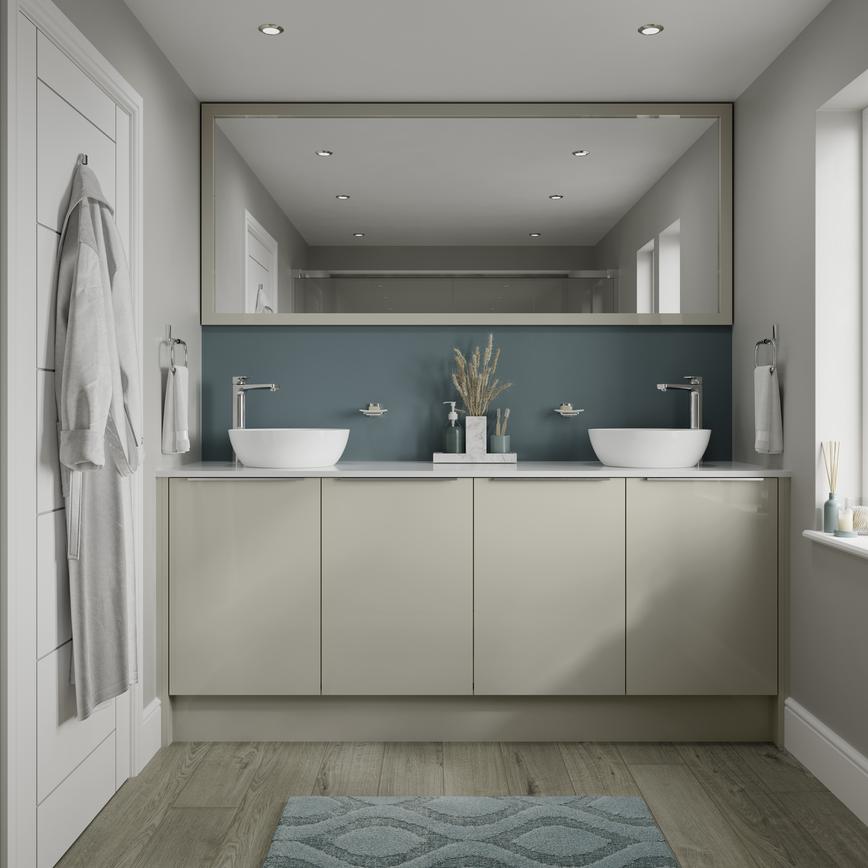 Small slab bathroom with gloss cupboard doors in sandstone. Has two white sinks, chrome handles and taps, plus a teal wall.