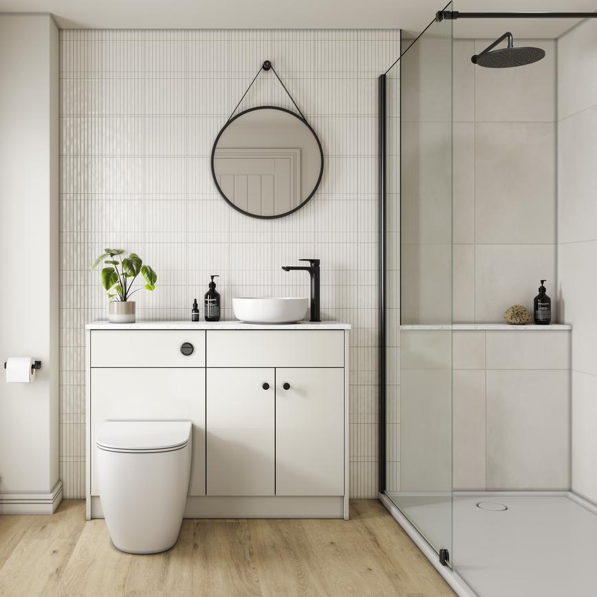 A porcelain, slab kitchen in a single wall layout. There are white worktops, plank flooring, and a black tap.