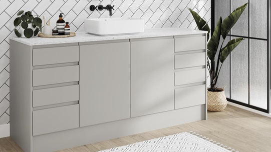 Modern bathroom in soft dove grey colour and matt finish. Features integrated handles and oak floors for a pared-back look. 