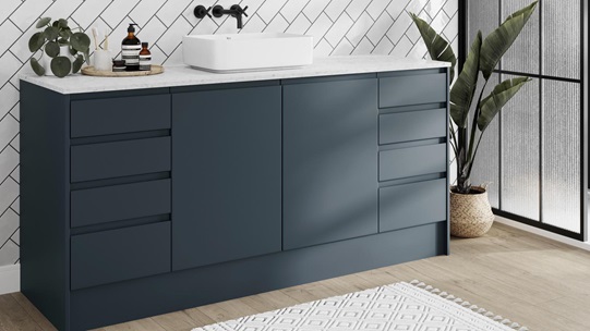 A contemporary marine blue bathroom, with slab door fronts and integrated handles in a matt finish for a modern look.