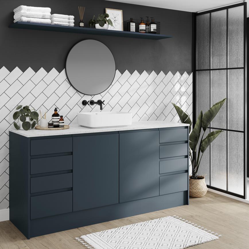 A contemporary marine blue bathroom, with slab door fronts and integrated handles in a matt finish for a modern look.