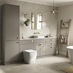 A large, sand grey bathroom with a single wall design. It has golden handles and taps, a white sink, and tile flooring.