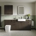 A bathroom with textured units in a walnut-effect finish. It has white fixtures, matching wall cabinets and painted panels.