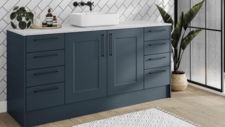 A marine blue bathroom with shaker cupboards in a single wall layout. Includes black bar handles for a sleek, statement look.