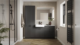 A single-wall, shaker bathroom in a charcoal tone. It has herringbone flooring, white worktops, and a ceramic sink.