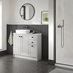 A single-wall, shaker bathroom in a dove grey tone. It has tile flooring, a ceramic sink, and dark oak wall panelling.