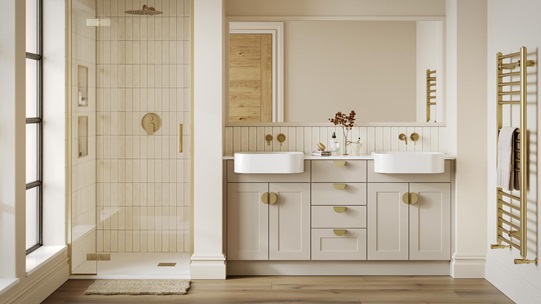 A single-wall, shaker bathroom in a sandstone tone. It has gold taps and handles, dual ceramic sinks, and timber flooring.