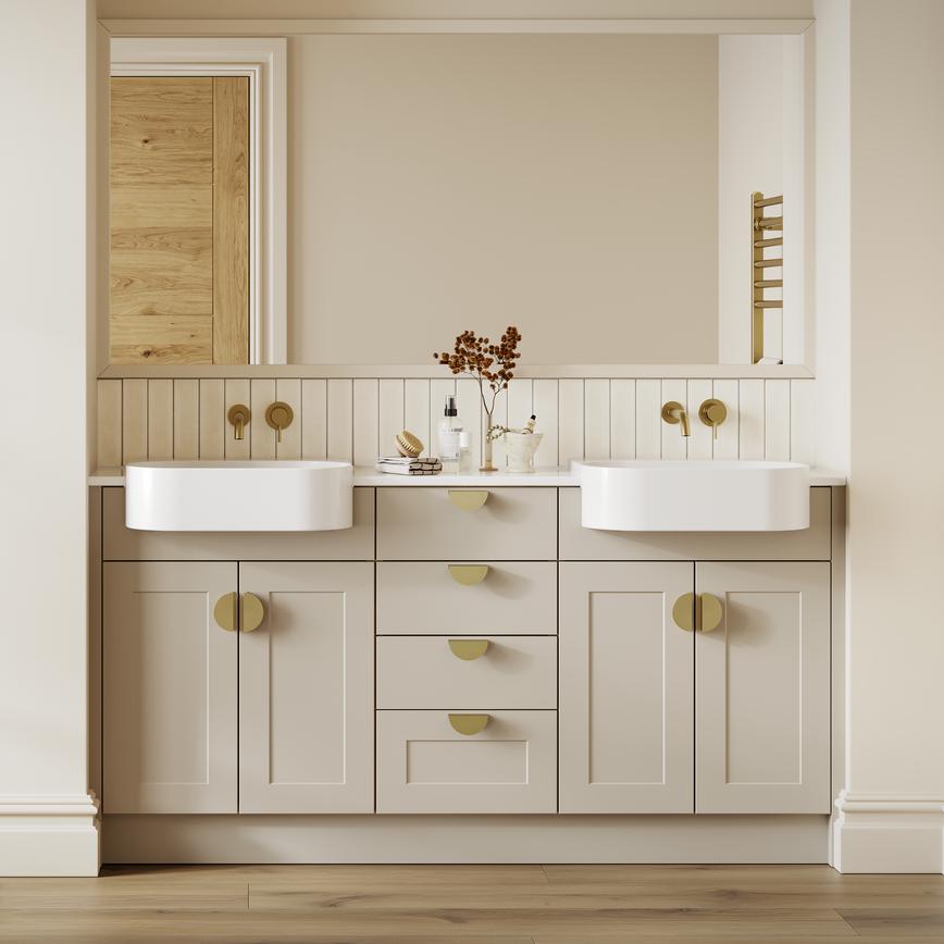 A single-wall, shaker bathroom in a sandstone tone. It has gold taps and handles, dual ceramic sinks, and timber flooring.