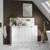 A small white bathroom with gloss cabinets and brass fittings. There is marble wall panelling and matching floors throughout