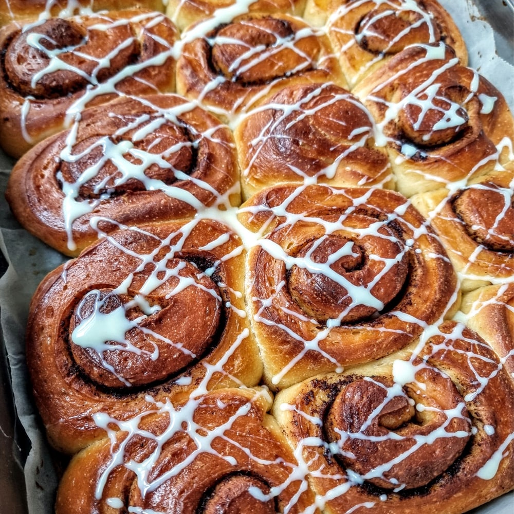 Cinnamon bun's in a grid layout, with white icing drizzled on top.