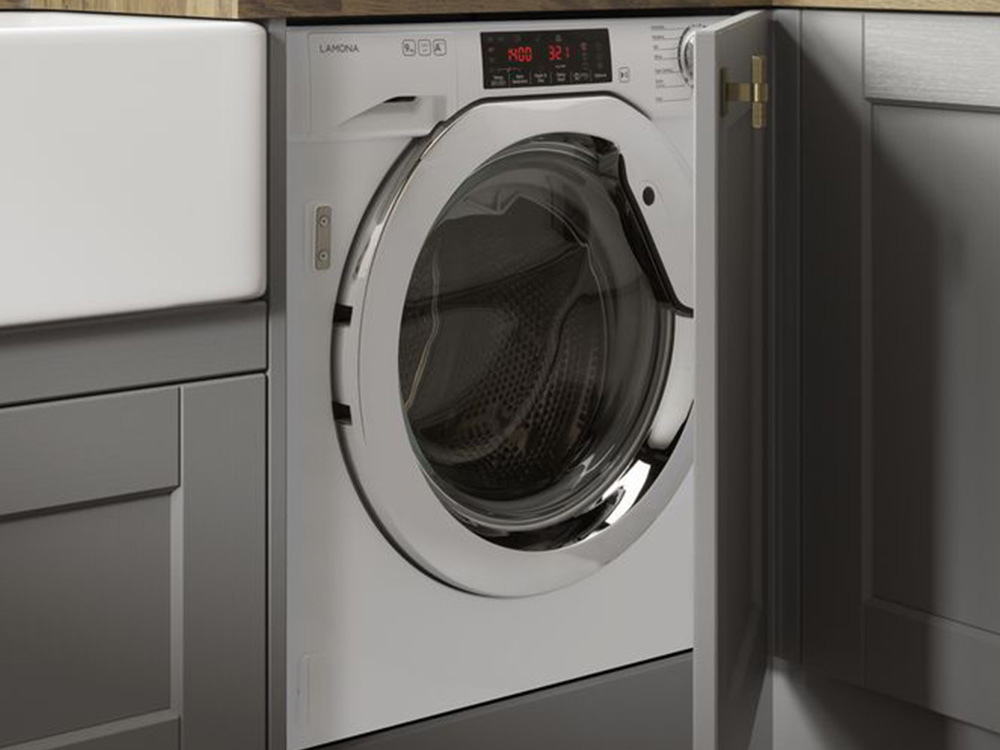 Integrated washing machine with a light grey shaker door and wooden counter tops.