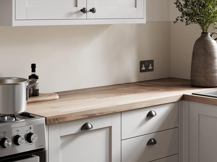 A dove grey shaker kitchen with a timber worktop