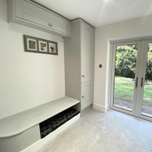 Boot room storage idea using wall and tall grey cabinets for storing space and to create a bench.