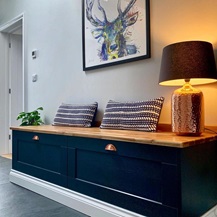 Combining deep drawers with a countertop for a boot room storage idea that creates a comfy bench.